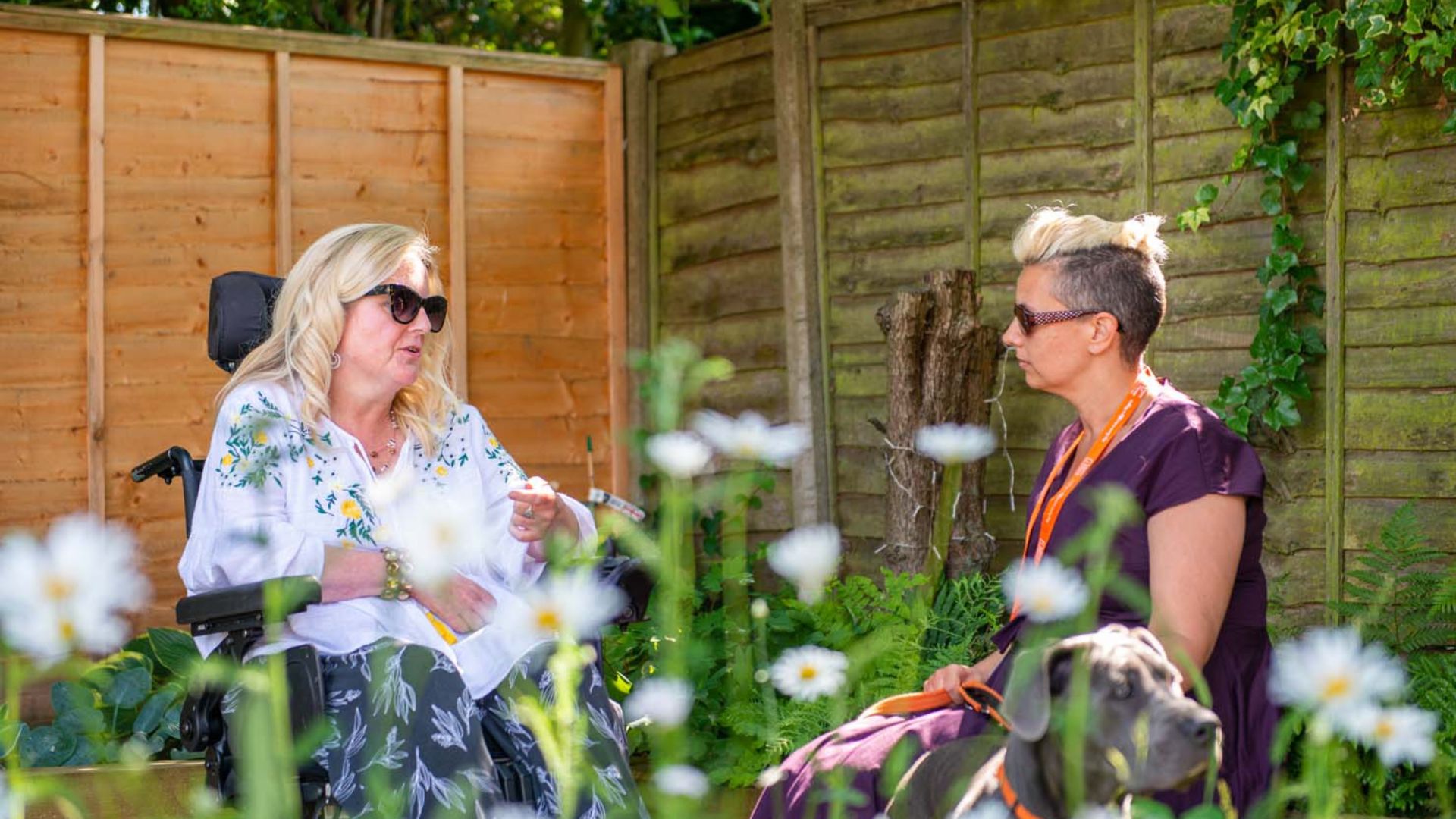 homecare Client and CareGiver chatting in a garden