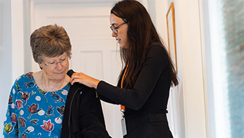 CareGiver assisting with jacket