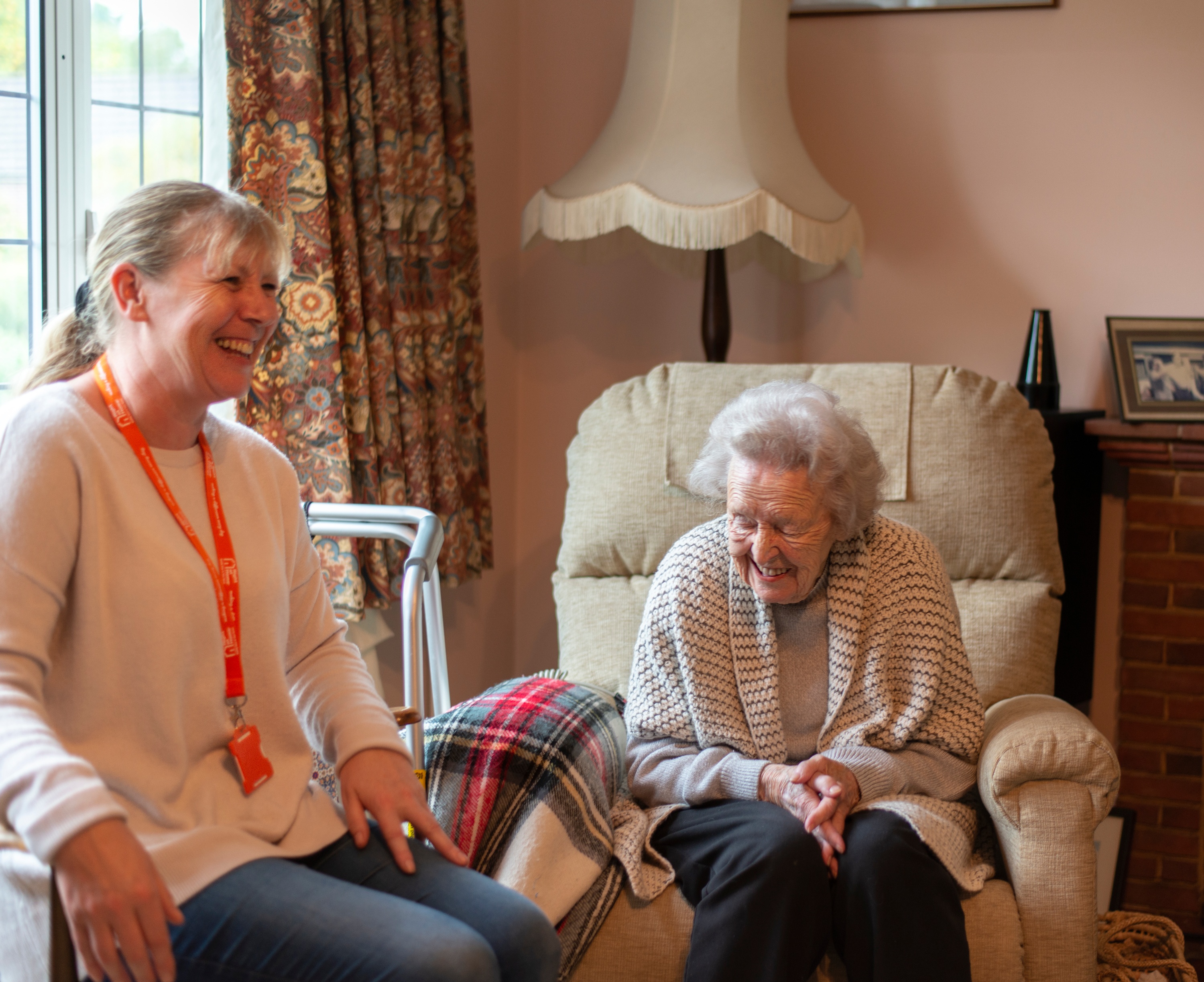 Elderly Client and Carer laughing together